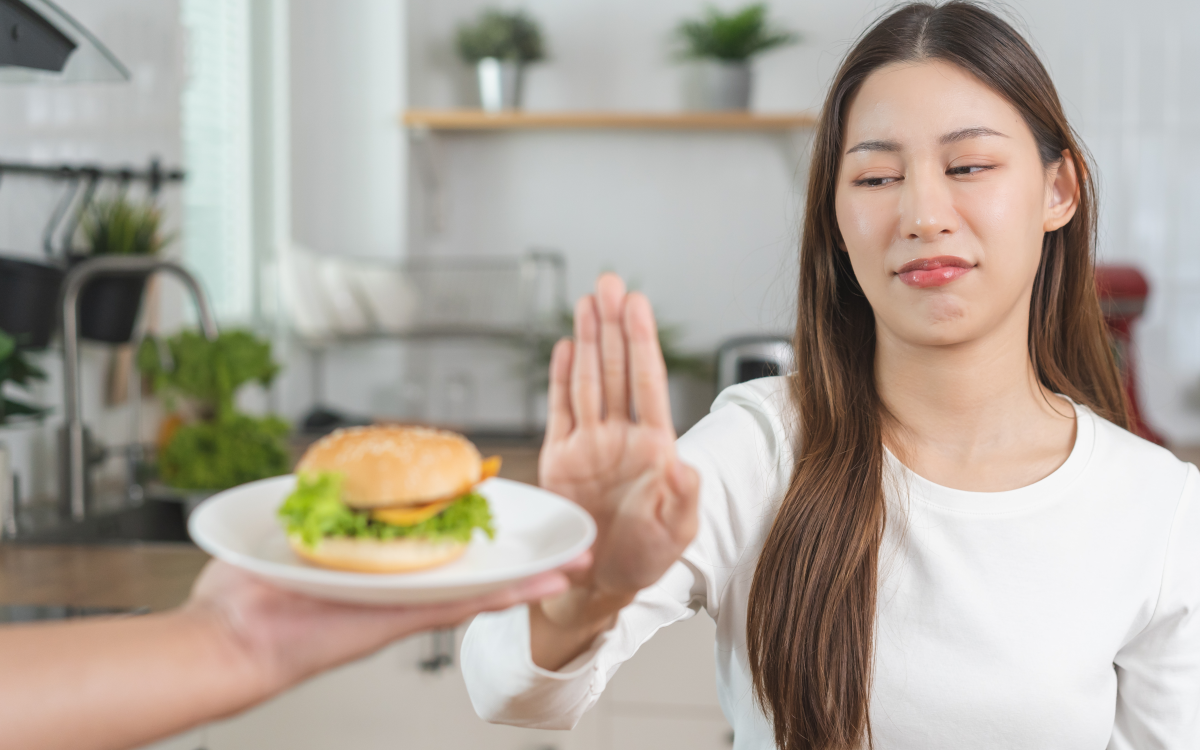woman refusing a sandwich
